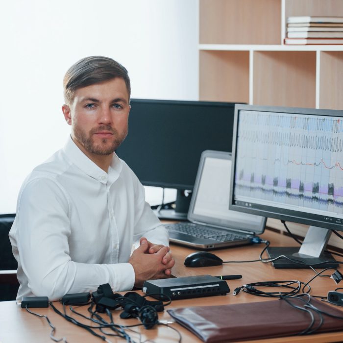 In the workplace. Polygraph examiner works with his lie detector's equipment